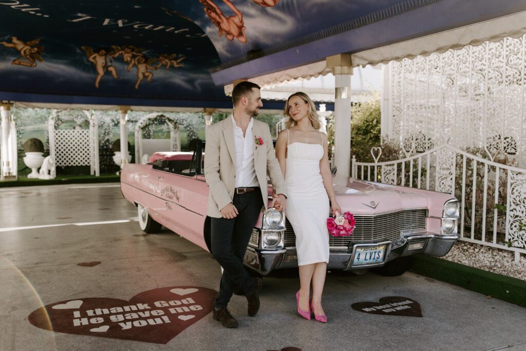 Wedding photos with pink Cadillac at A Little White Chapel.
