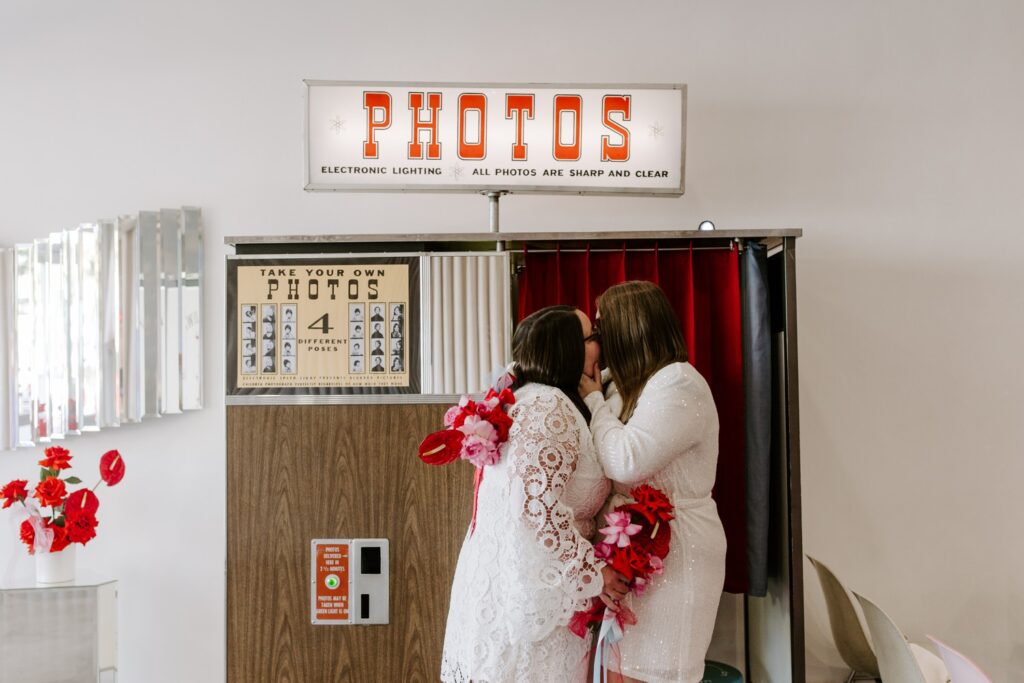 Couple kissing at photo booth in Sure Thing Chapel in Las Vegas. 