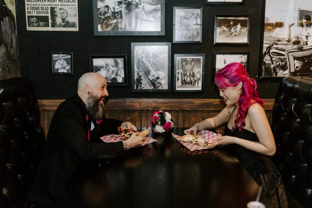 Couple eating pizza during elopement in Las Vegas. 