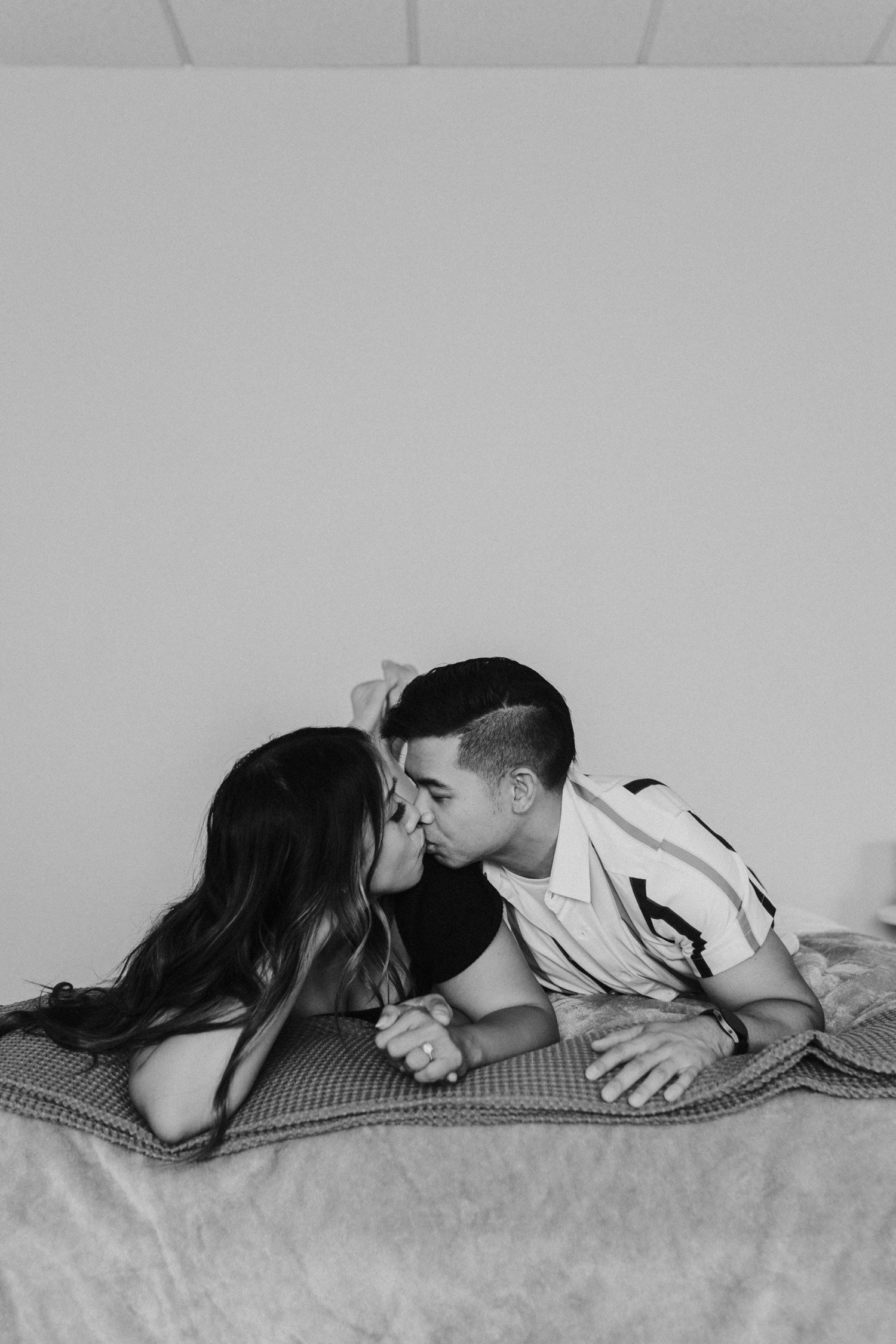 Couple Kissing on Bed for Engagement Photos