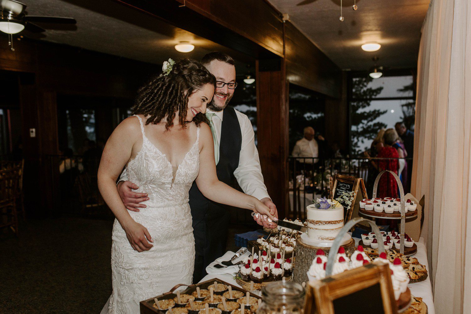 Bride and groom cutting cake at heavenly mountain resort