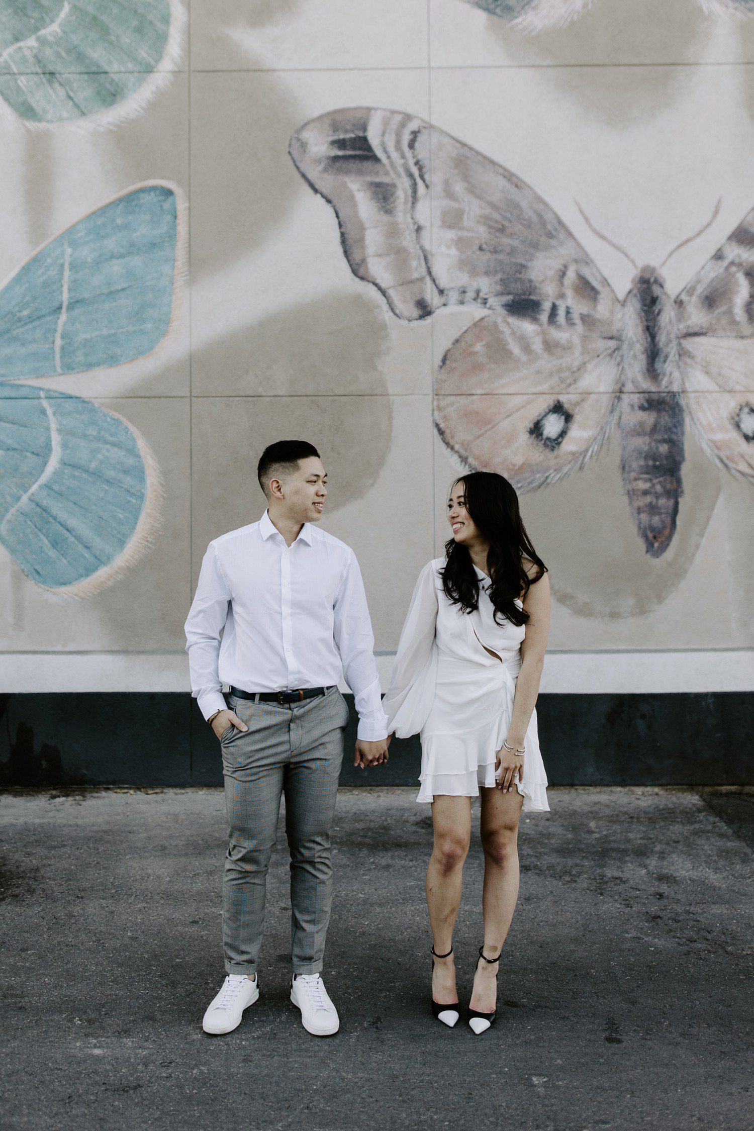 Couple in front of butterfly mural in Las Vegas. 