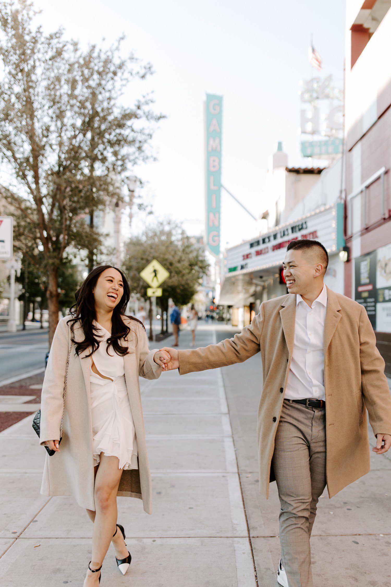 Fremont street engagement photos with couple walking. 