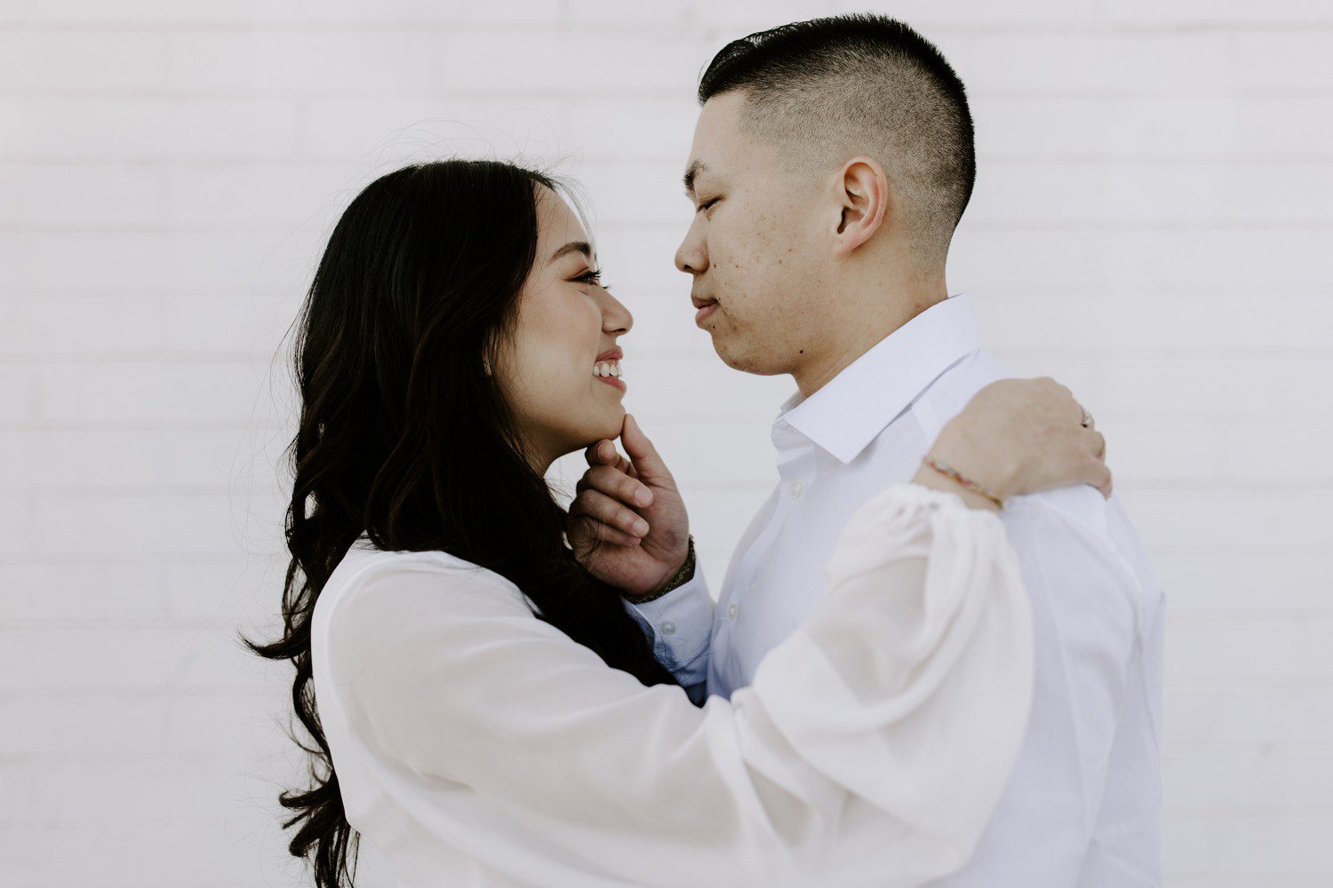 Couple in white for engagement photos. 
