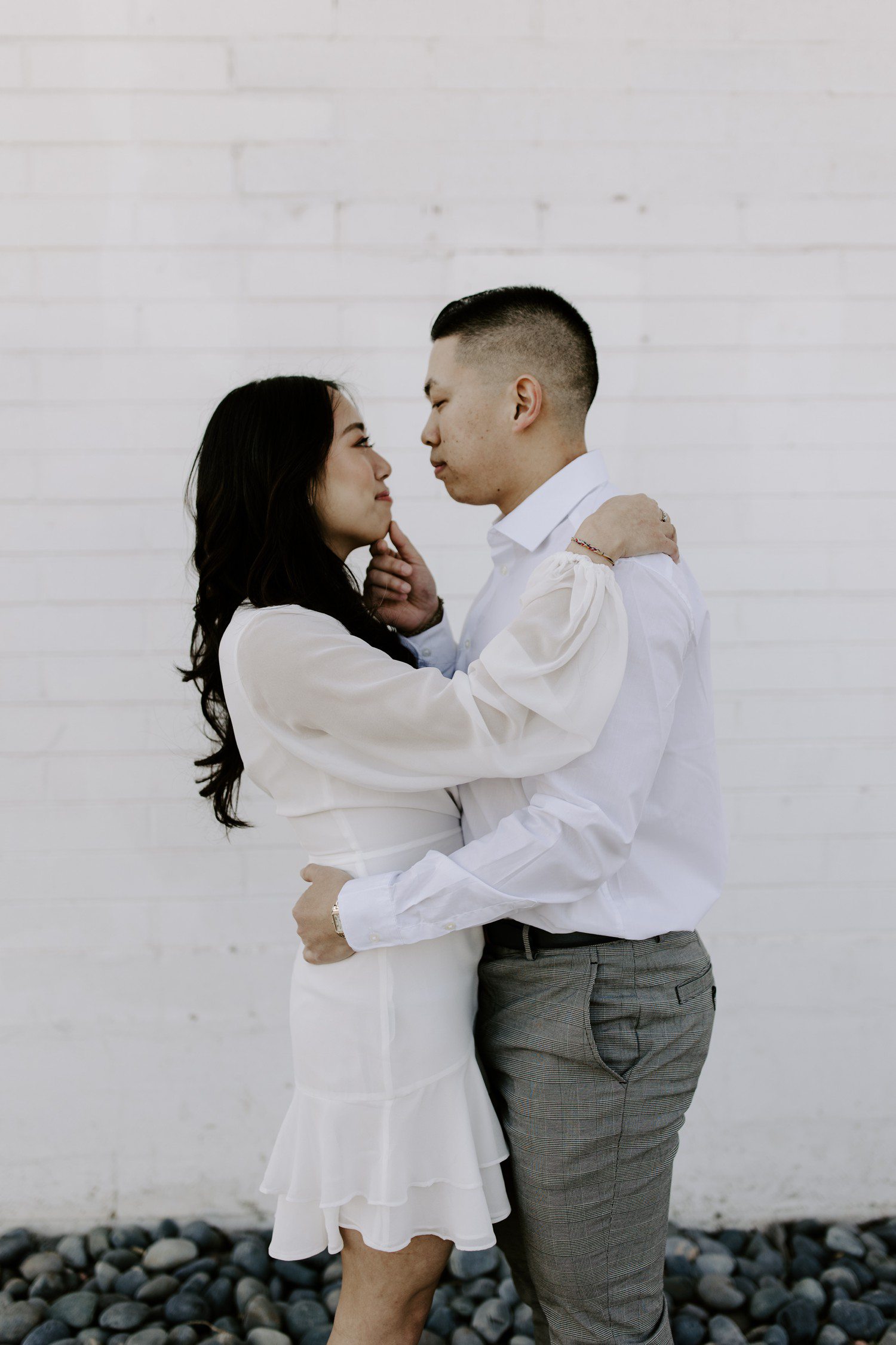 Couple in white for engagement session photos. 
