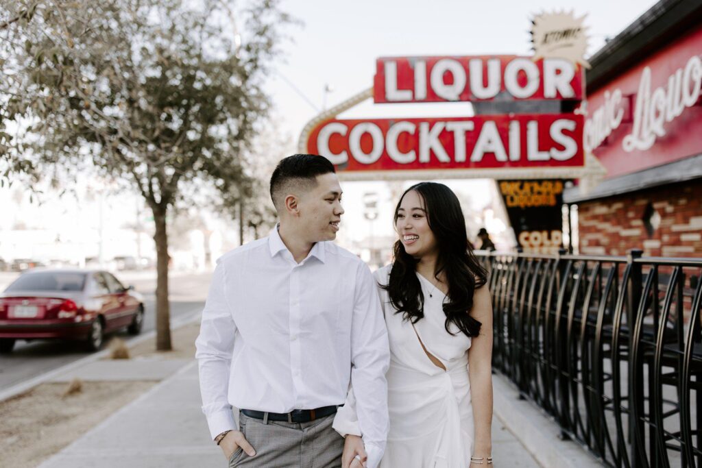 Couple walking together for Fremont Street engagement photos in Las Vegas.