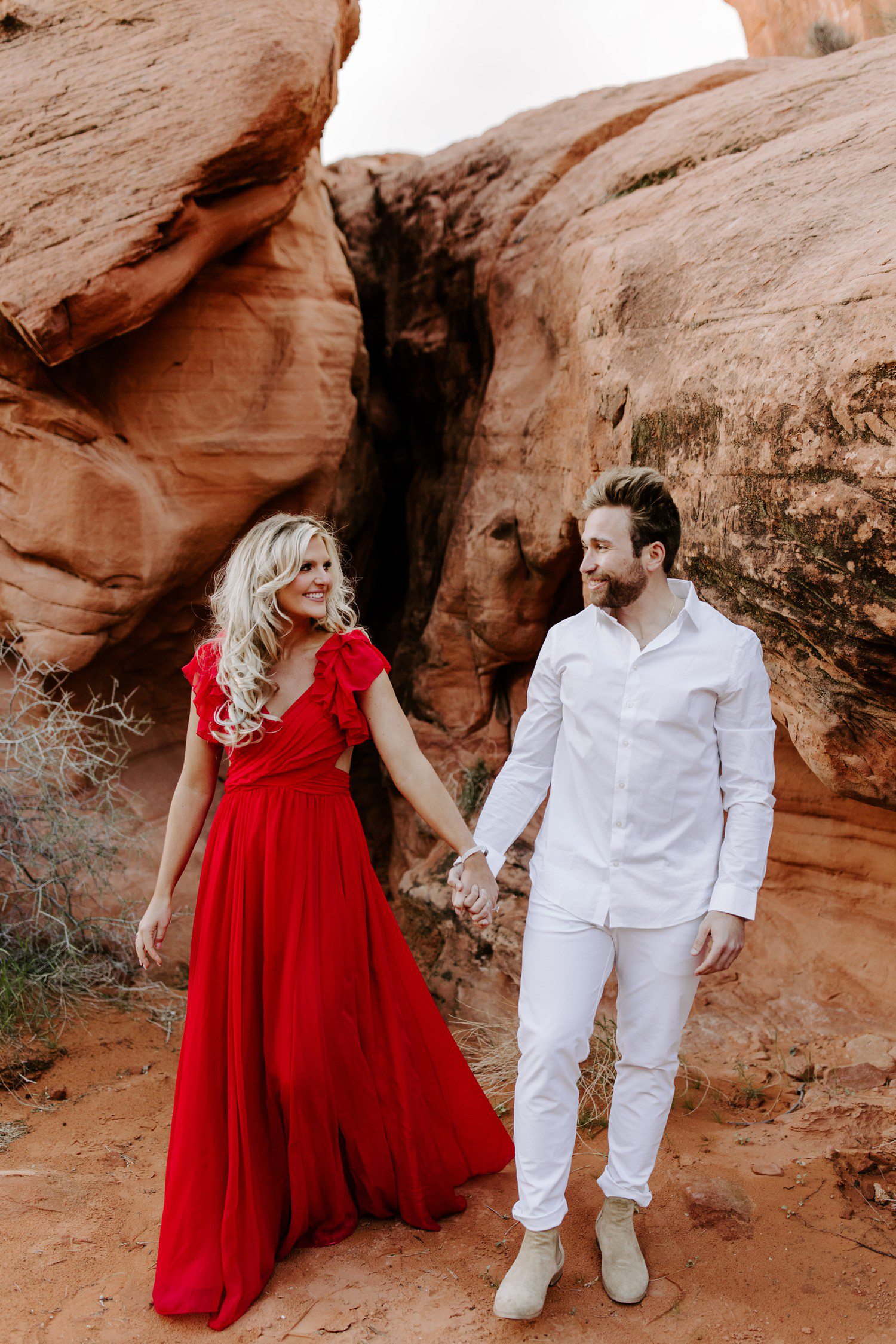 Las Vegas engagement photos at Valley of Fire with girl in red dress. 
