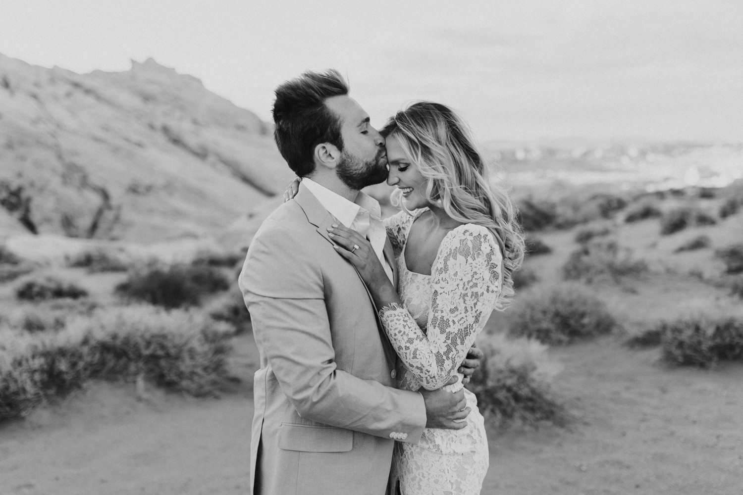 Guy kissing girl on forehead for Valley of Fire Engagement photos. 