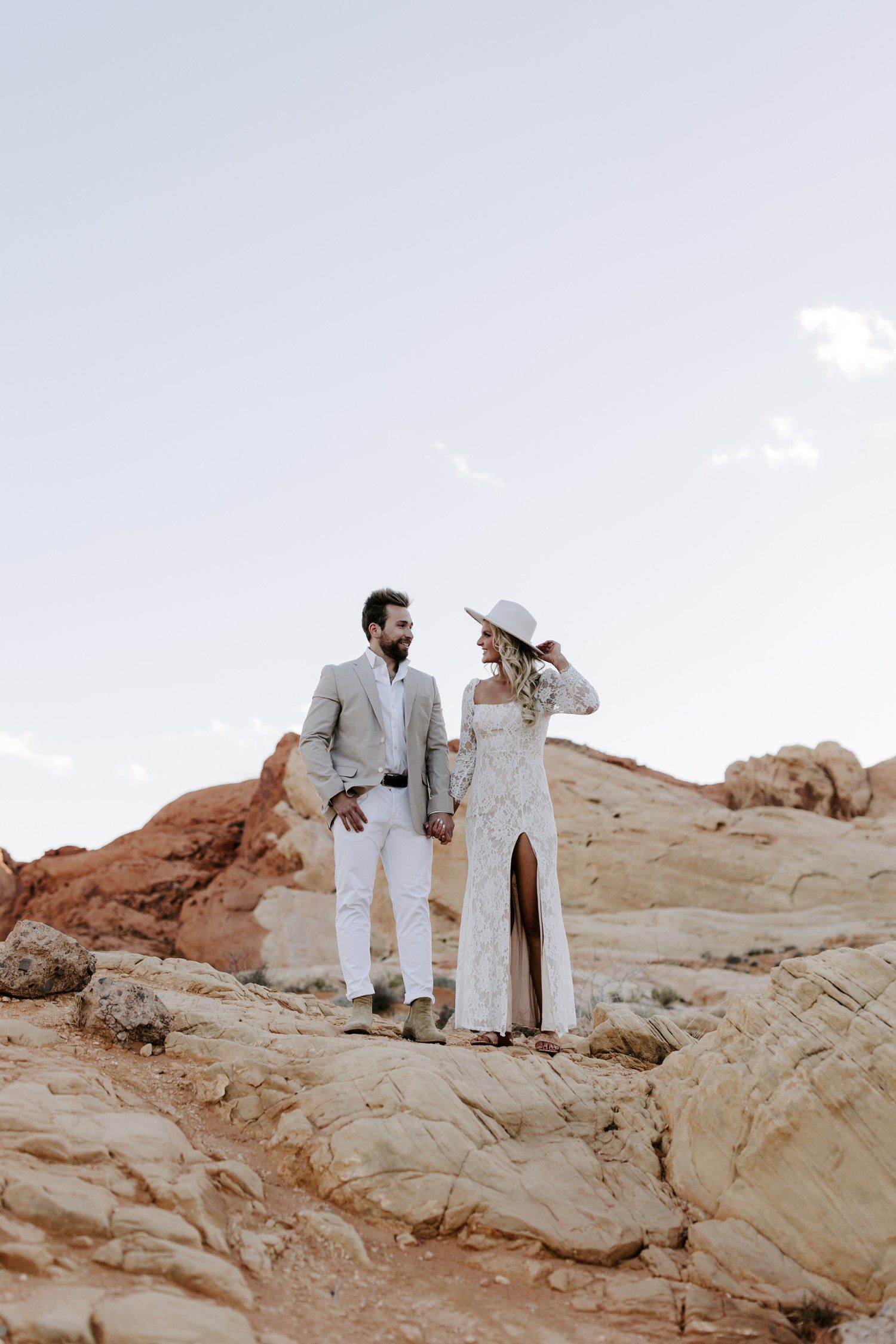 Las Vegas engagement session at Valley of Fire with girl in wearing white dress and hat. 