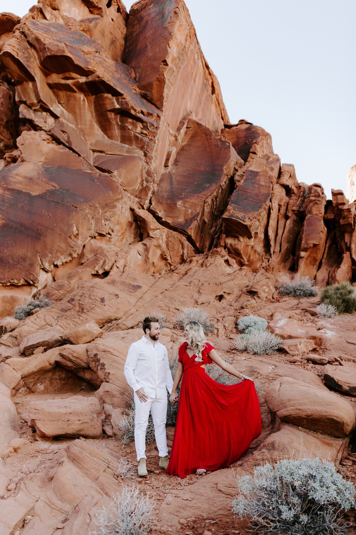 Engagement photos at Valley of Fire with red dress. 
