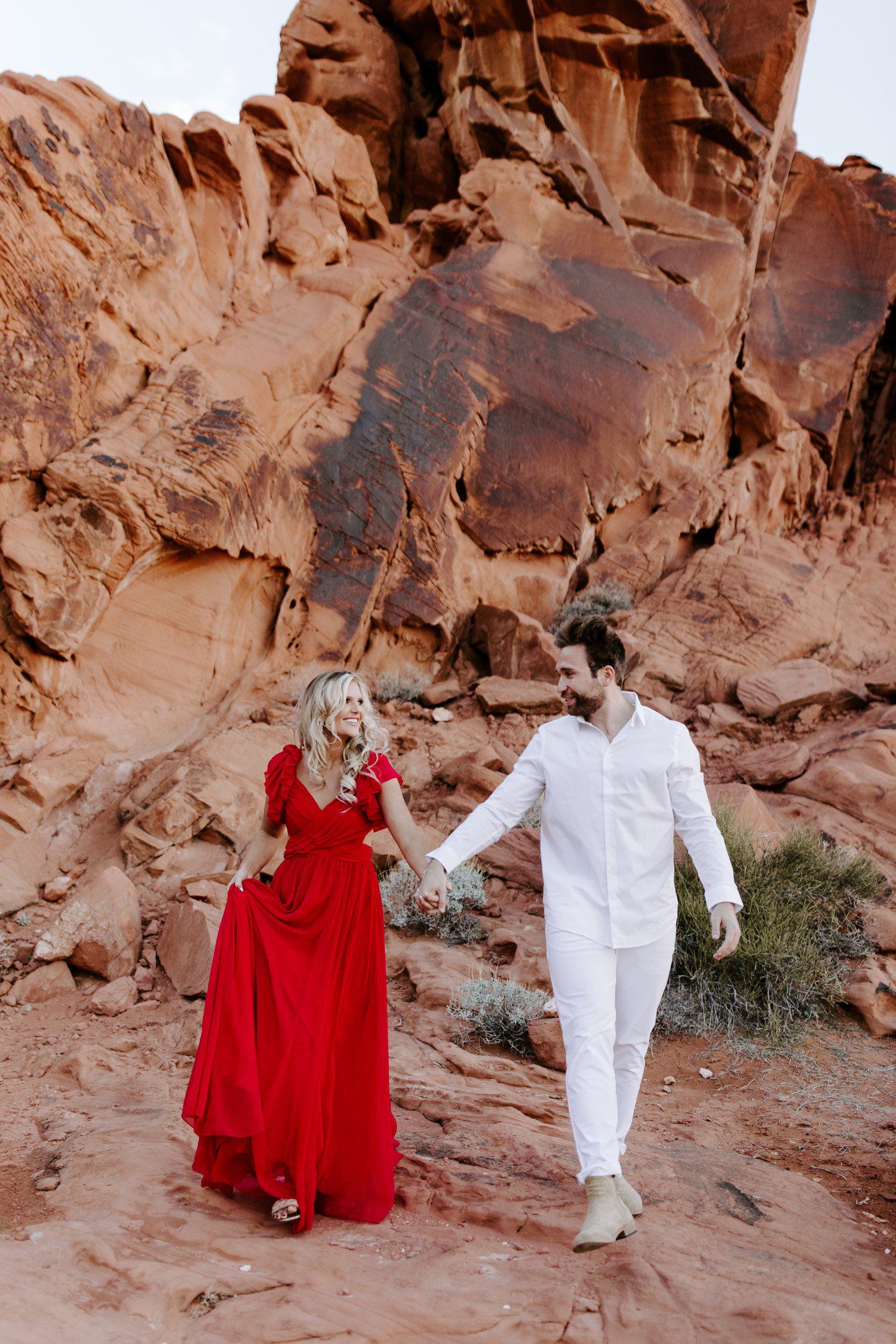 Couple walking during engagement photos at Valley of Fire outside of Las Vegas.