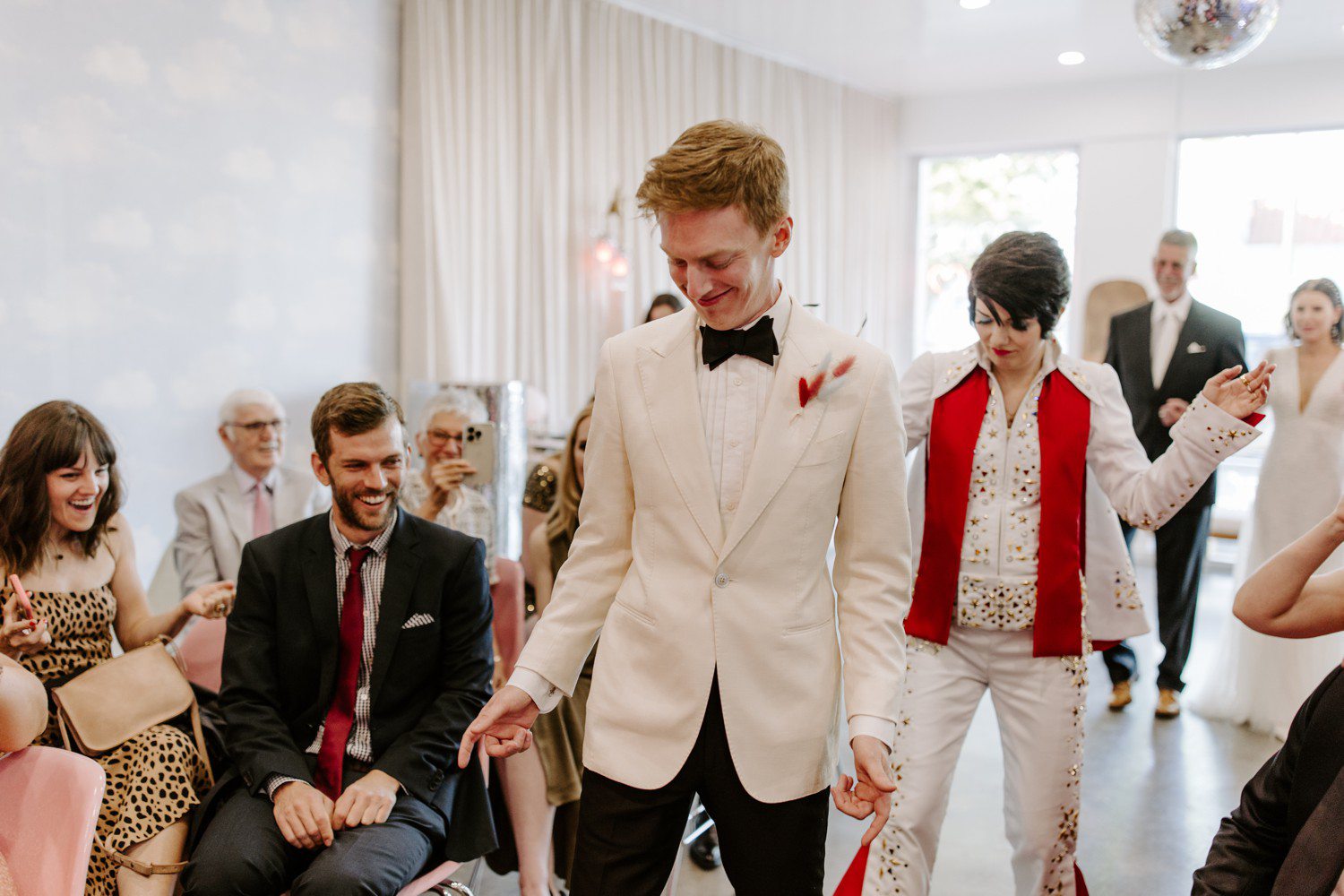 Groom and Elvis officiant walking down aisle