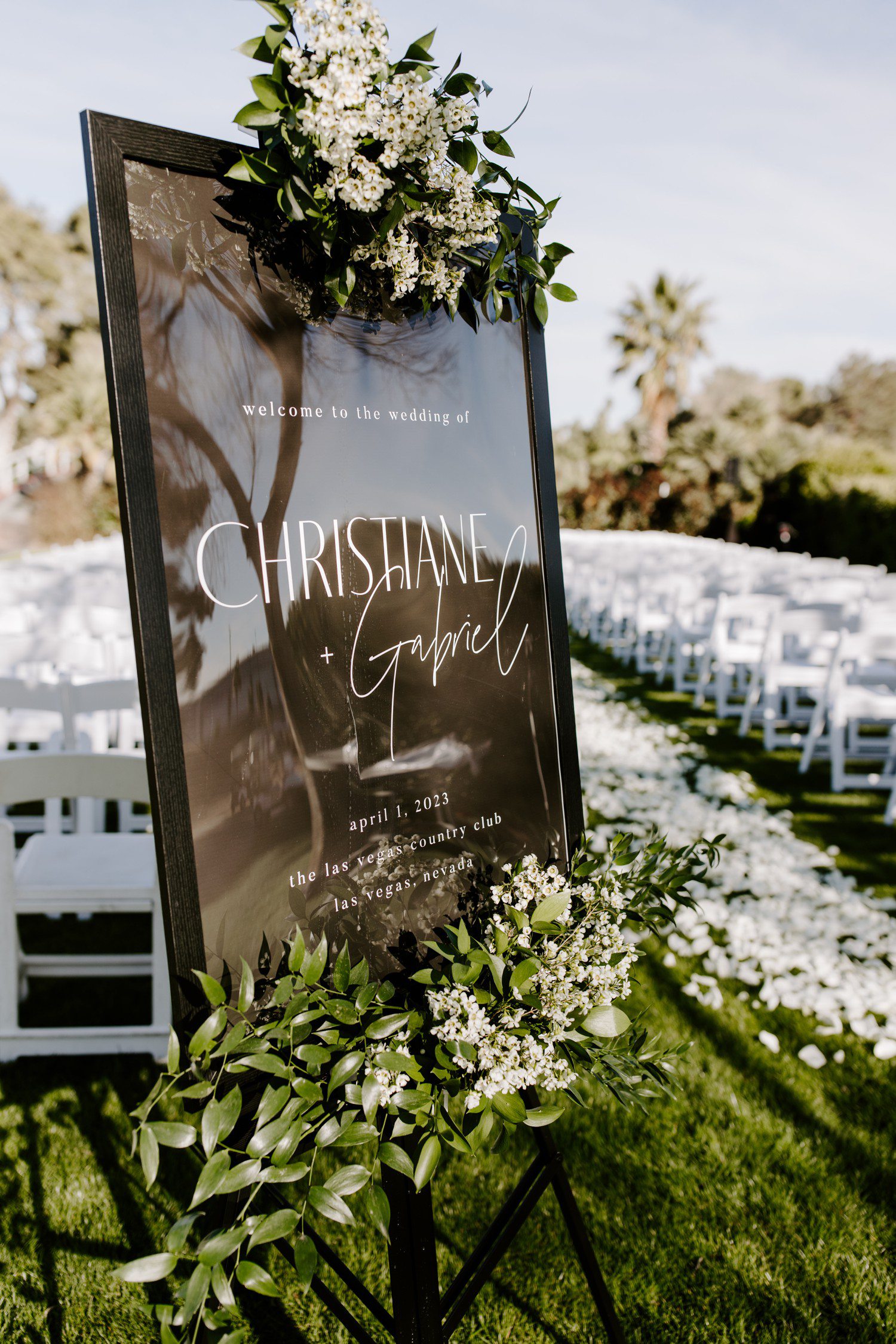 Black and white wedding sign with florals. 