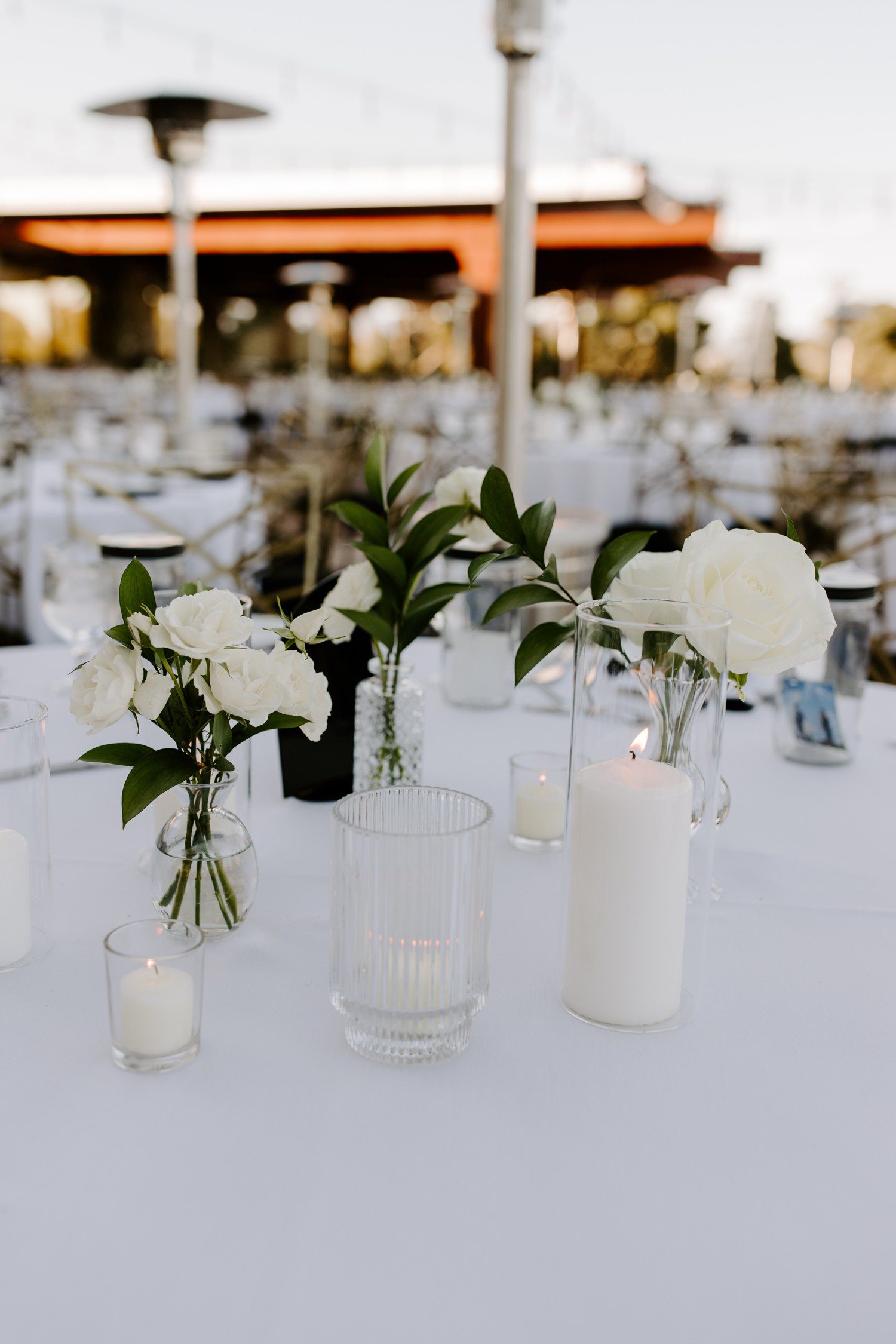 White wedding tables flowers and candles. 