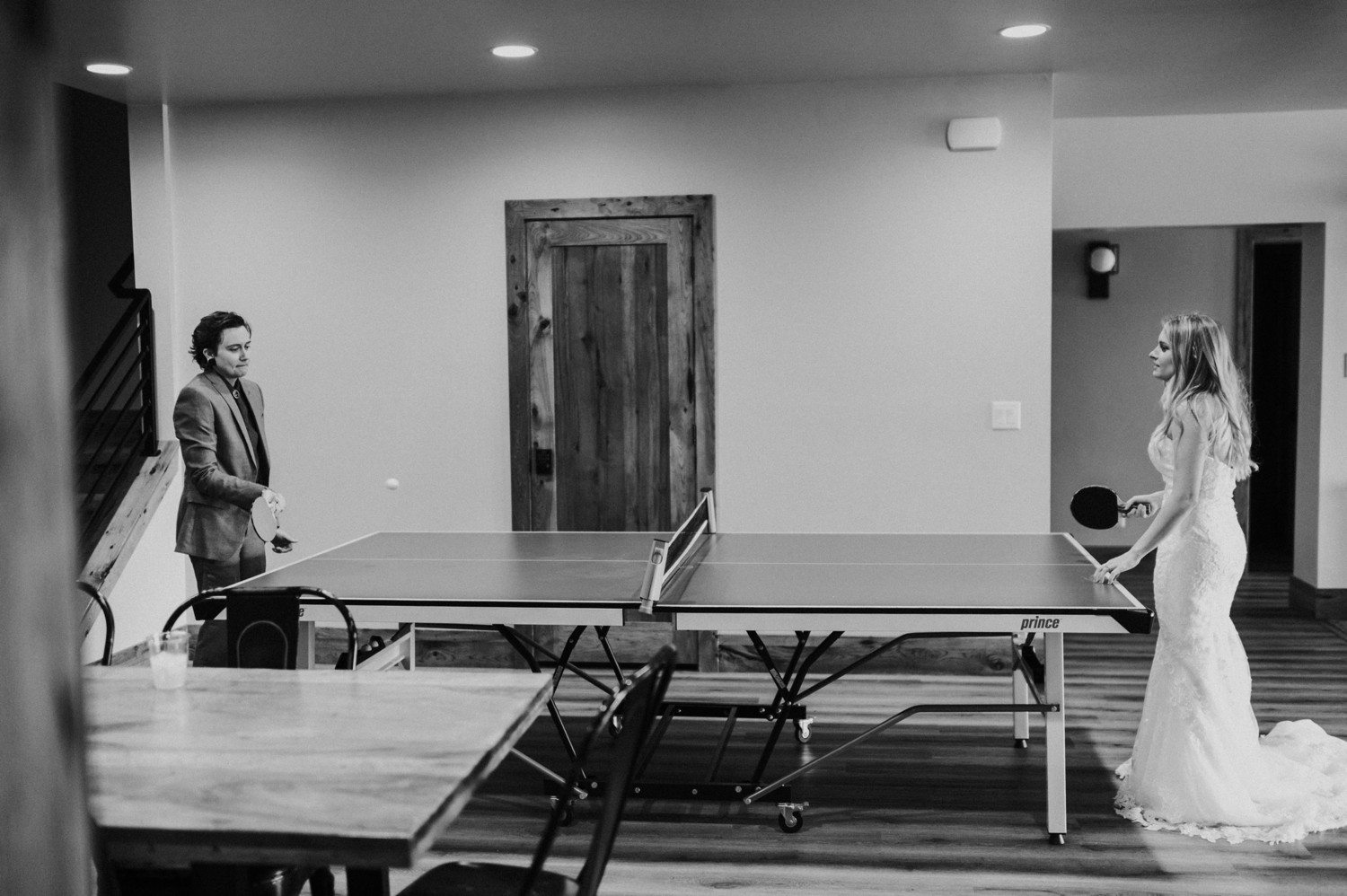 Couple playing ping pong before wedding.