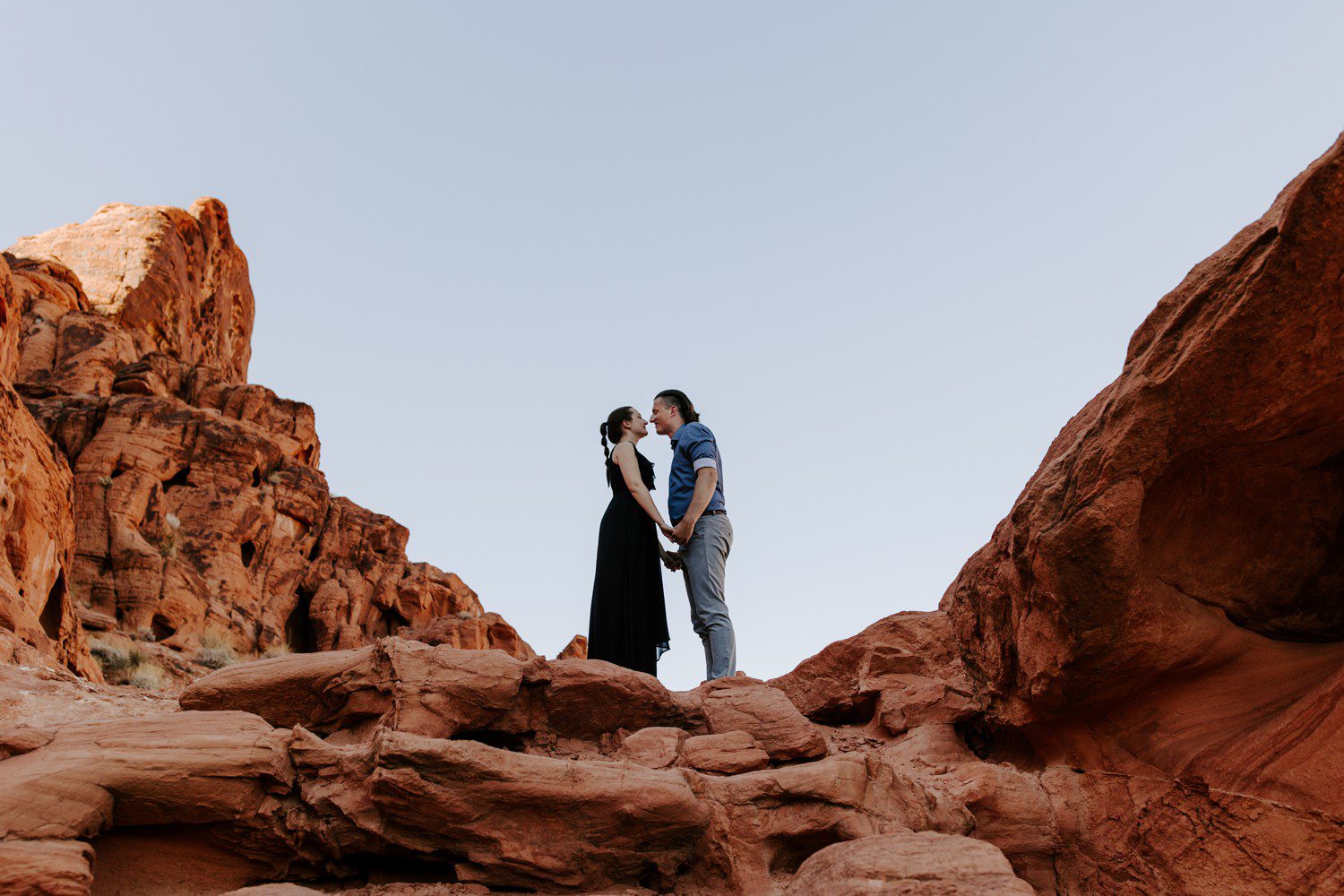 Couple standing on red sandstone at Valley of Fire. 