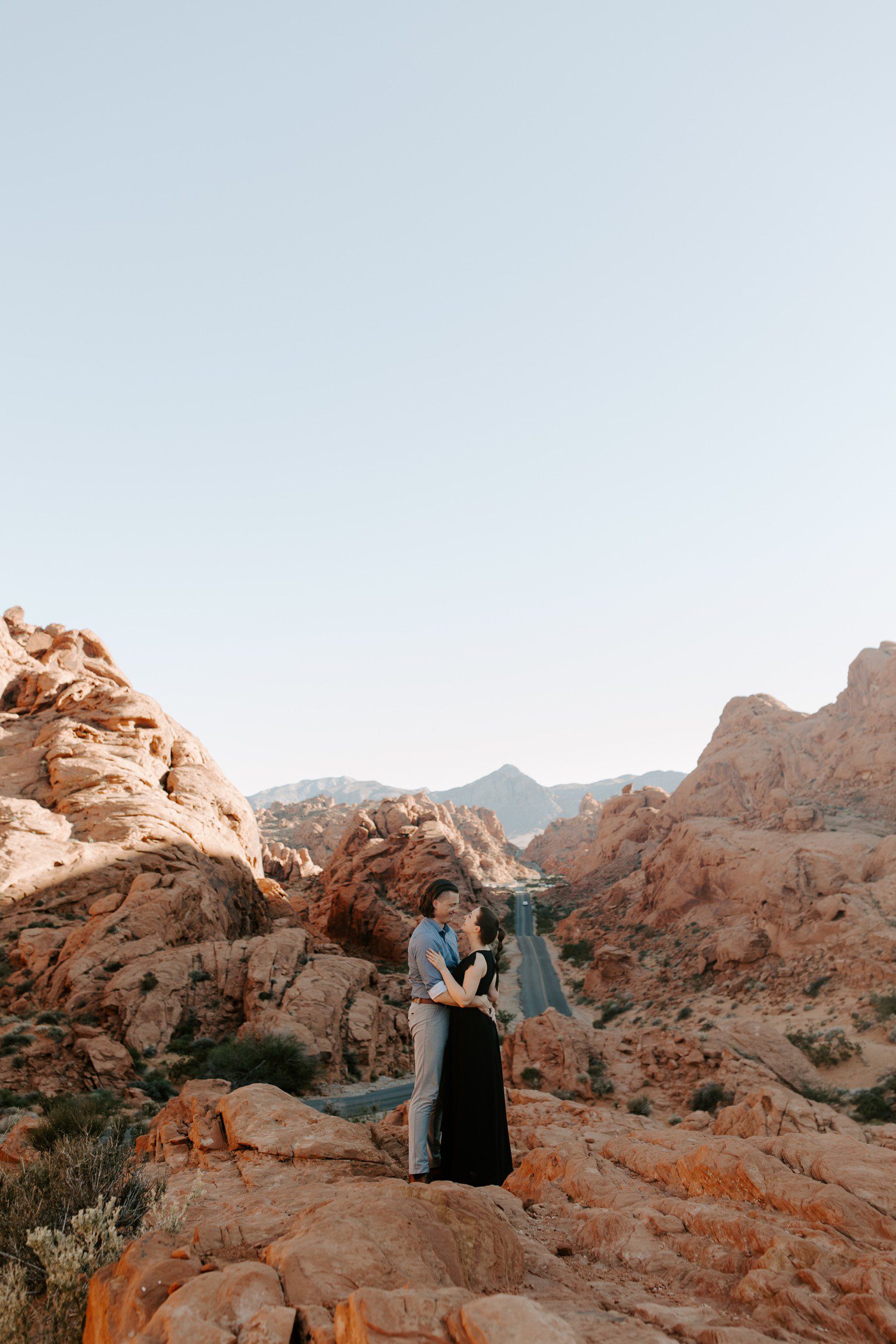 Couple standing together for engagement session at Valley of Fire. 
