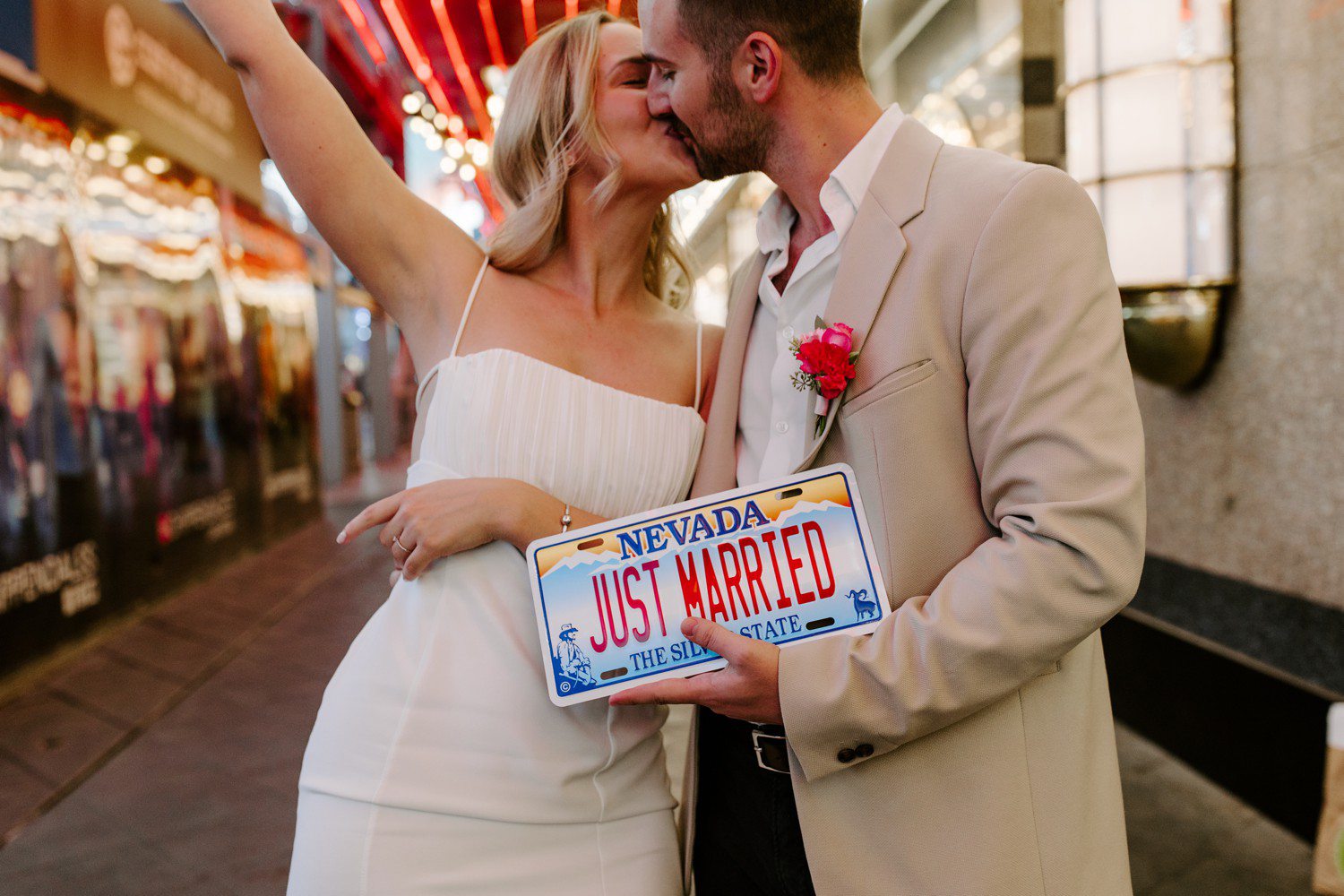 Couple kissing with just married sign on Fremont street.