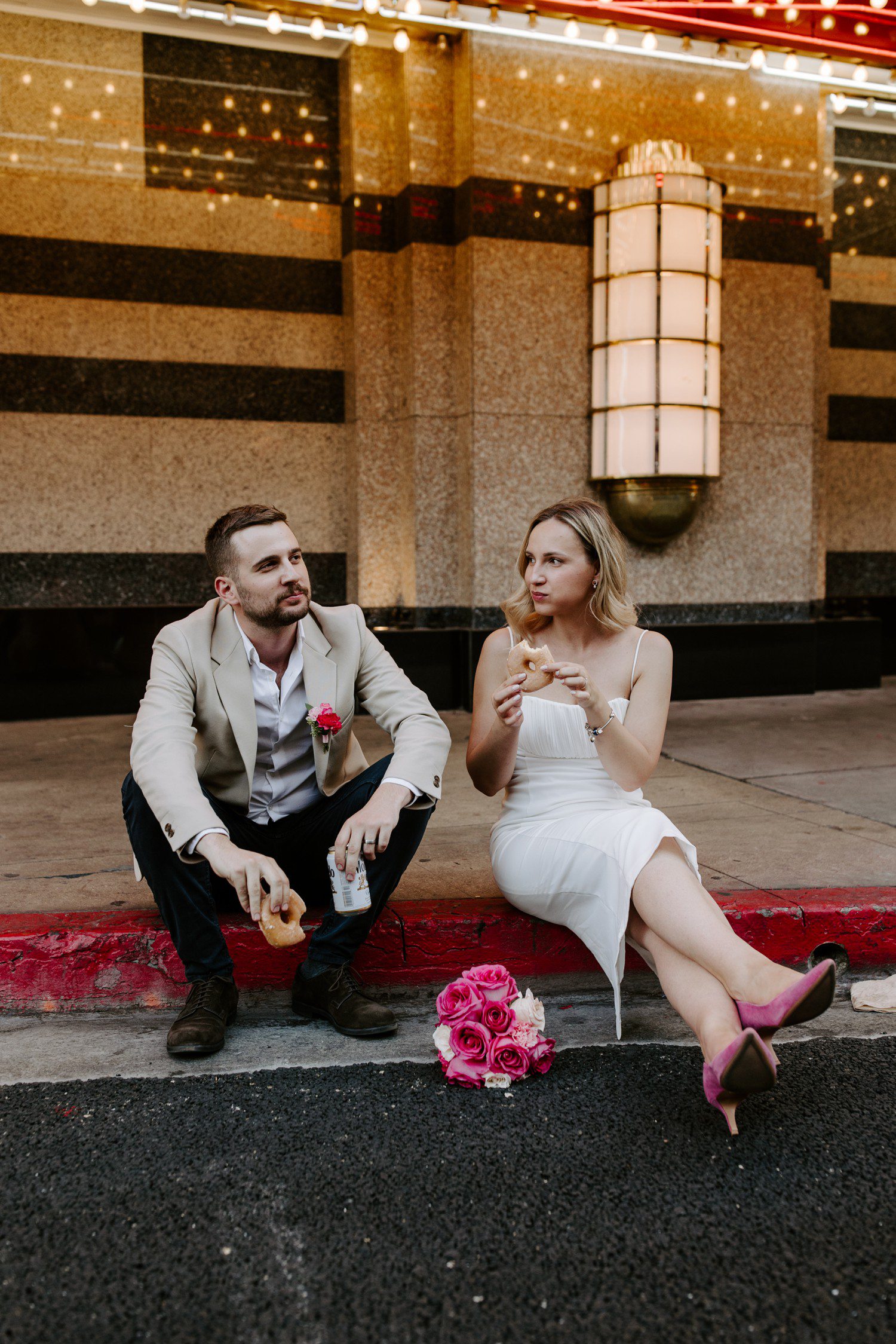 Elopement photos on Fremont street with donuts and beer.