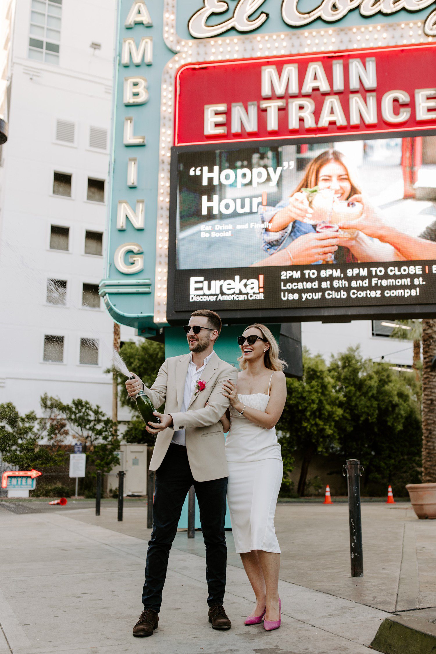 Popping champagne to celebrate eloping in Las Vegas.