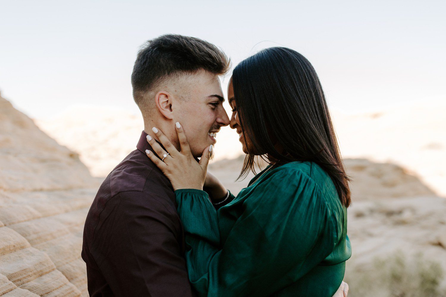Couple with noses together during engagement photos at Valley of Fire.