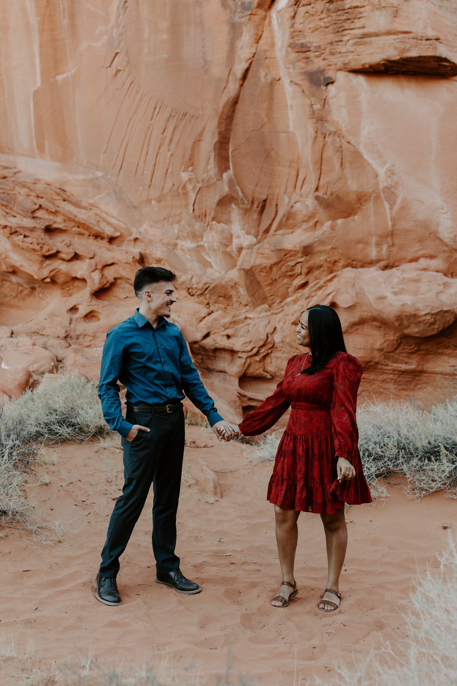 Couple holding hands during engagement photos at Valley of Fire.