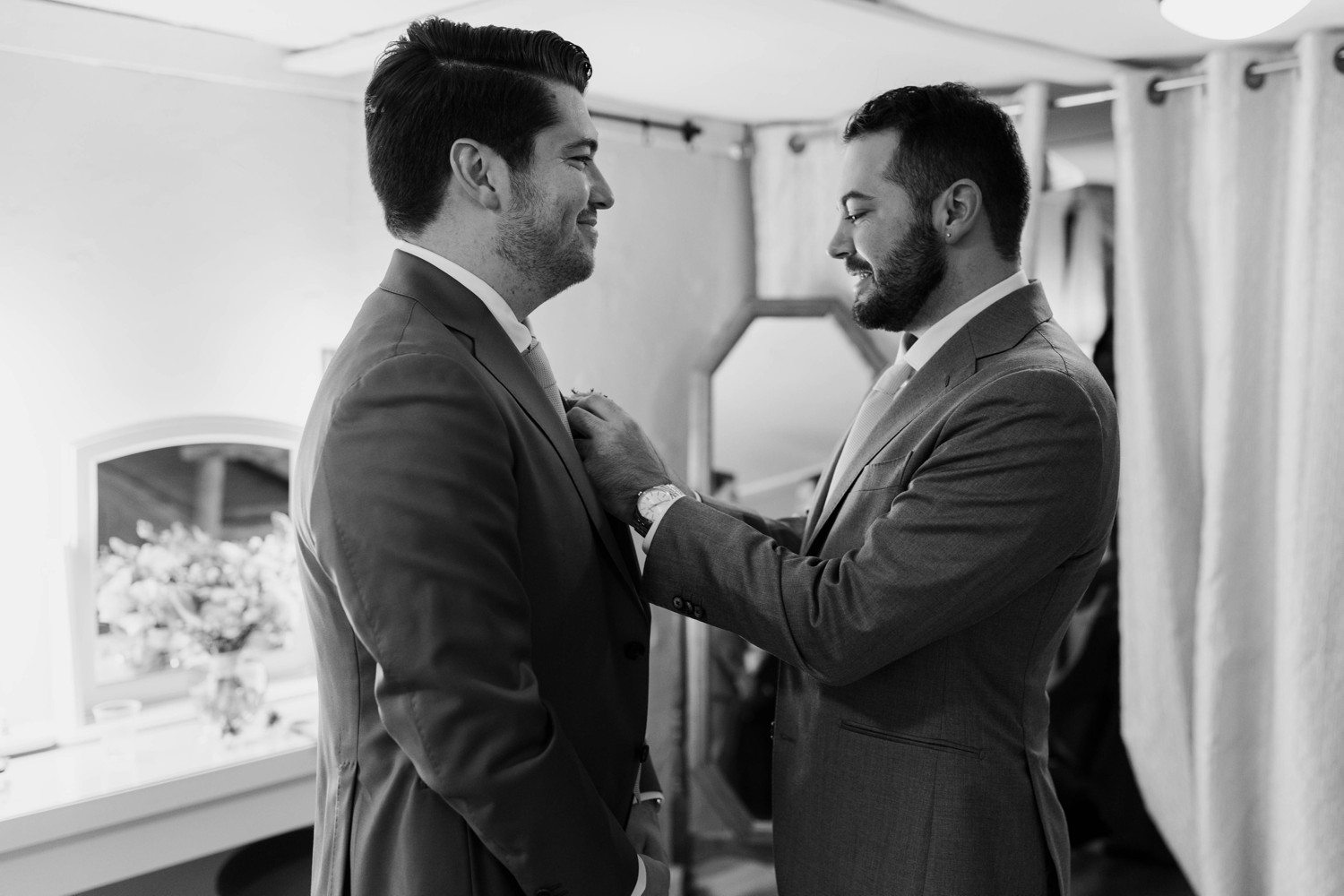 Two grooms getting ready for wedding together.