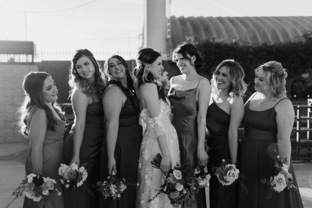Bride and bridesmaids laughing together.