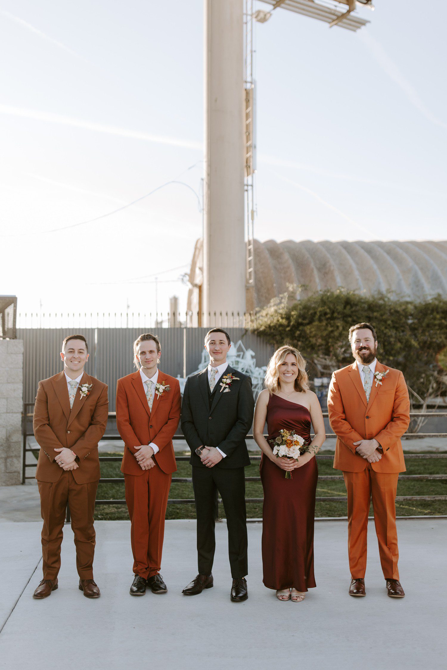 Groom and bridal party in fall color suits at The Doyle.