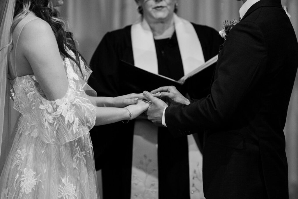 Bride and groom holding hands during wedding ceremony.