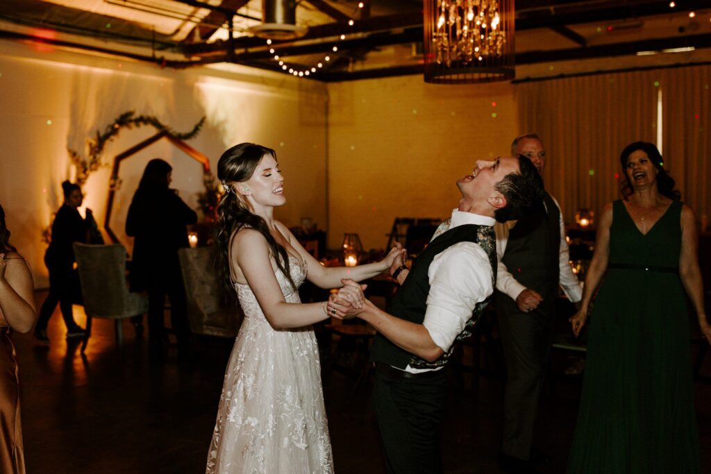 Bride and groom dancing together during wedding reception.