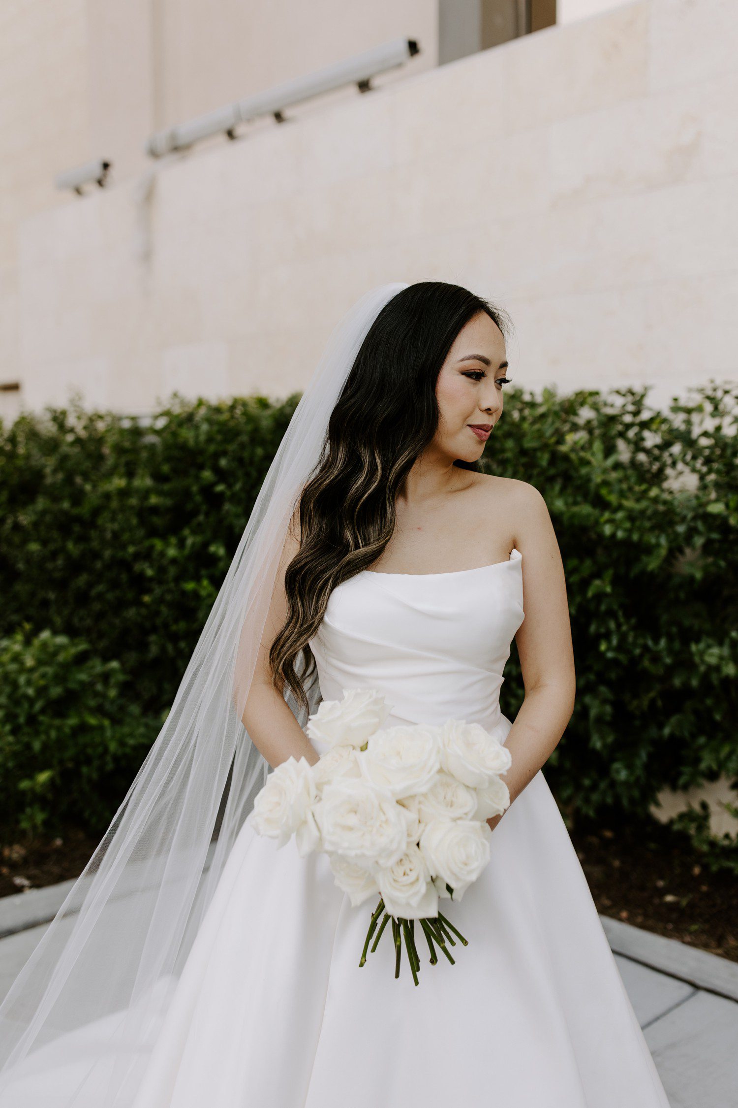 Bridal portraits with veil and white rose bridal bouquet.