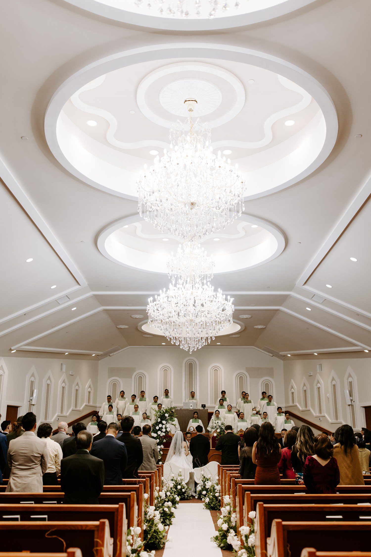 Indoor wedding ceremony with white flowers decorating aisle in Las Vegas.