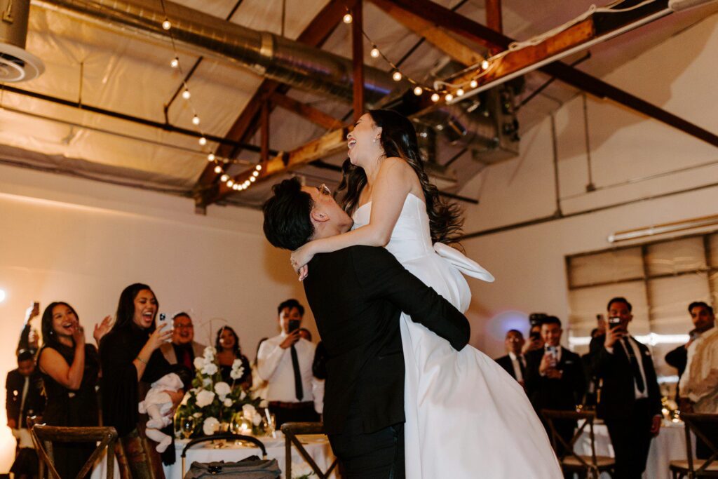 Groom picking up bride during wedding first dance at The Doyle.