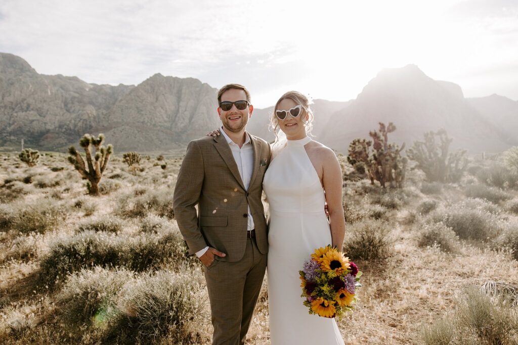 husband and wife stand with arms around each other at Spring Mountains elopement