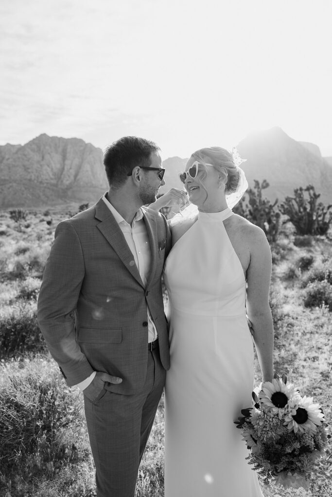 couple smiles at each other by Las Vegas wedding photographer