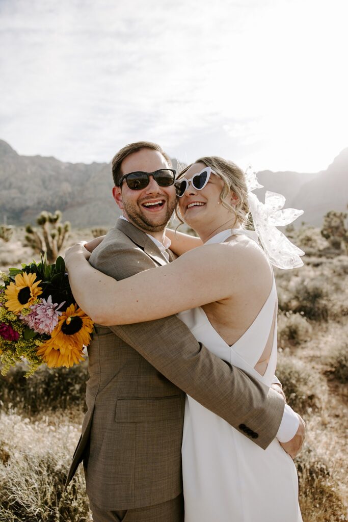 couple grin cheek to cheek with sunglasses on by Las Vegas wedding photographer