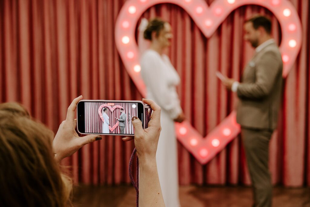 guest films vows at Vegas wedding by Katelyn Faye Photography