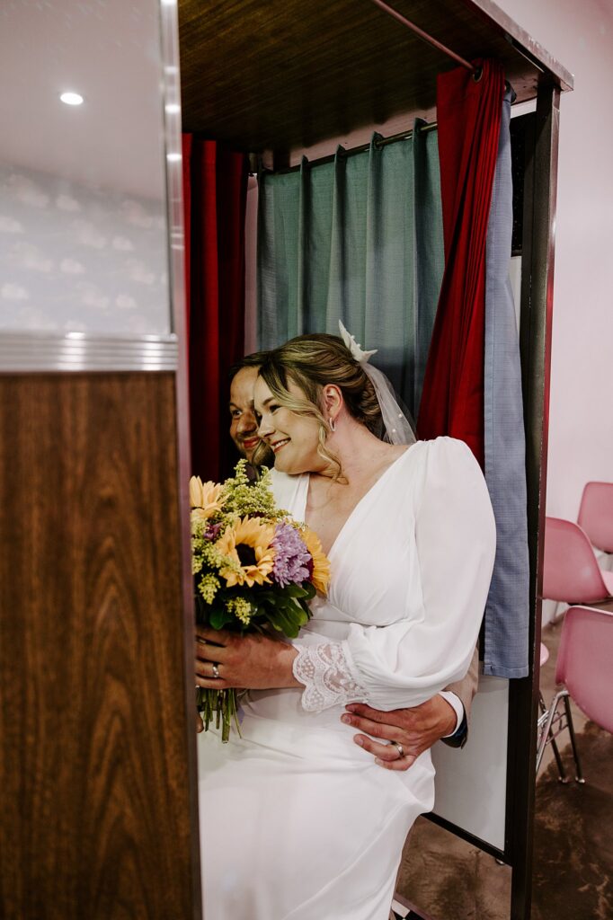 newlyweds smile for photobooth pictures after Spring Mountains elopement