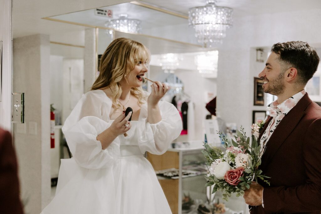 bride puts on lipstick before Elvis ceremony