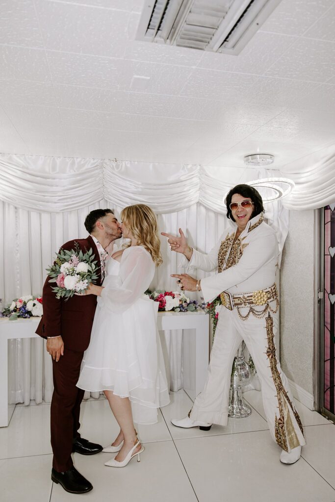 bride and groom share a kiss during Elvis ceremony