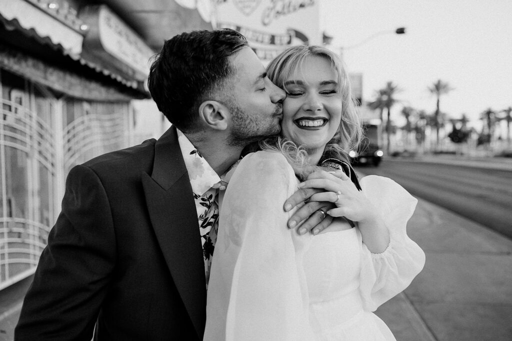 man kisses his bride on the cheek by Katelyn Faye photography