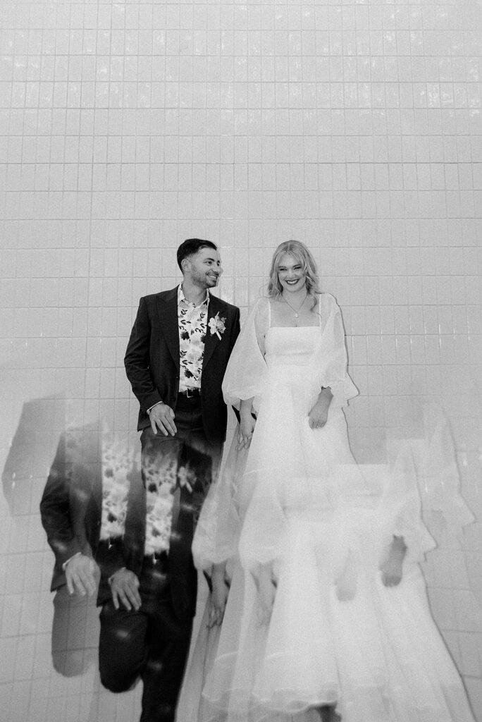 groom looks at bride as she smiles after Elvis ceremony