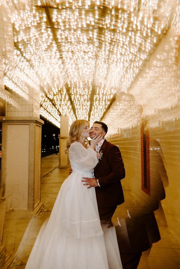 woman kisses man on cheek on her wedding day by Katelyn Faye photography