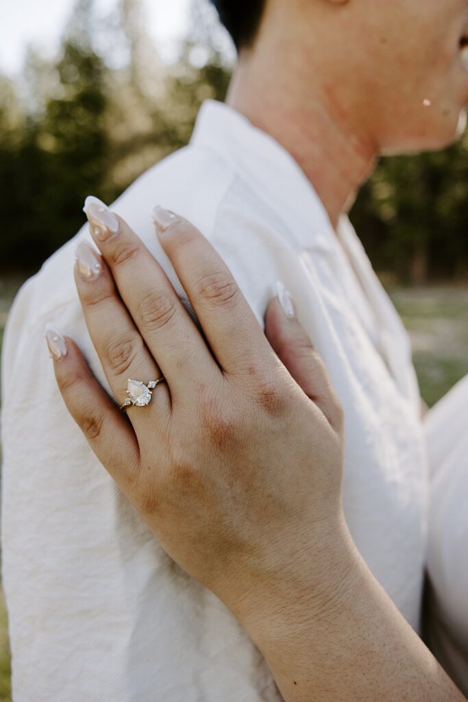 engagement ring shown off as hand rests on man's shoulder by Katelyn Faye Photography