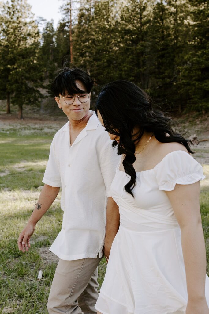 man smiles at his fiance as they walk together by Las Vegas wedding photographer