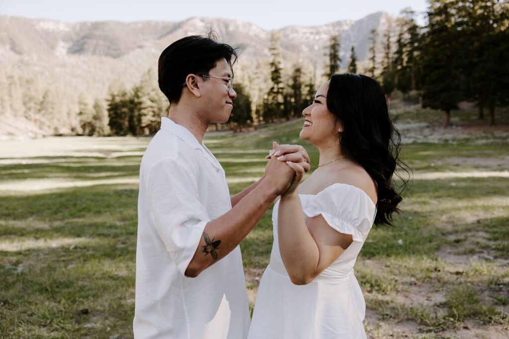 fiances hold hands up with fingers interlaced by Las Vegas wedding photographer