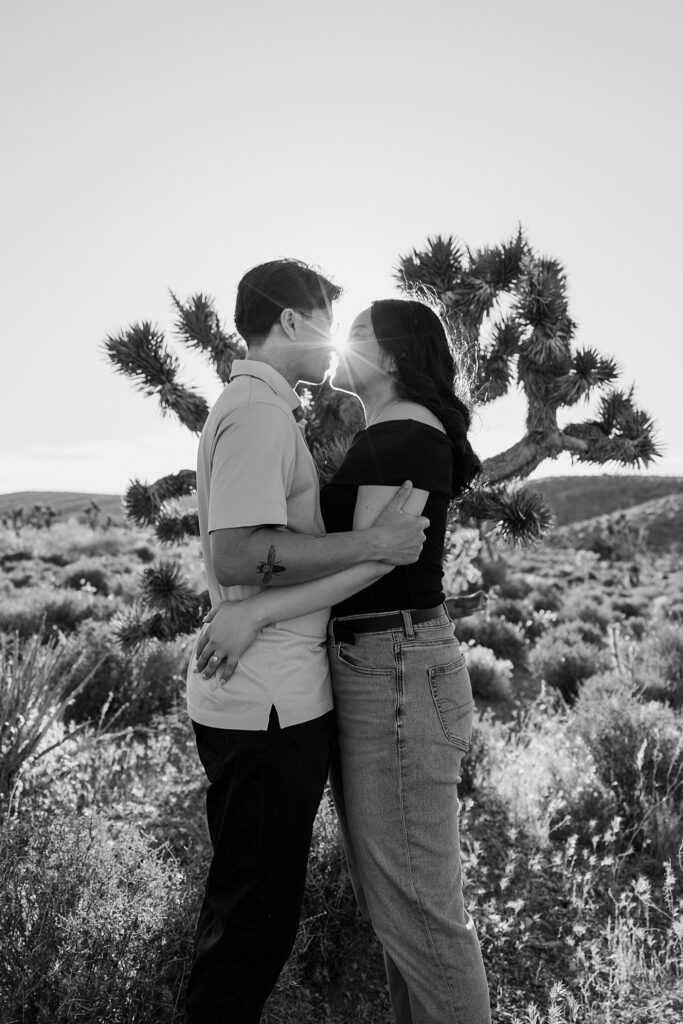 couple lean in for a kiss in front of yucca during Mt. Charleston engagement session 