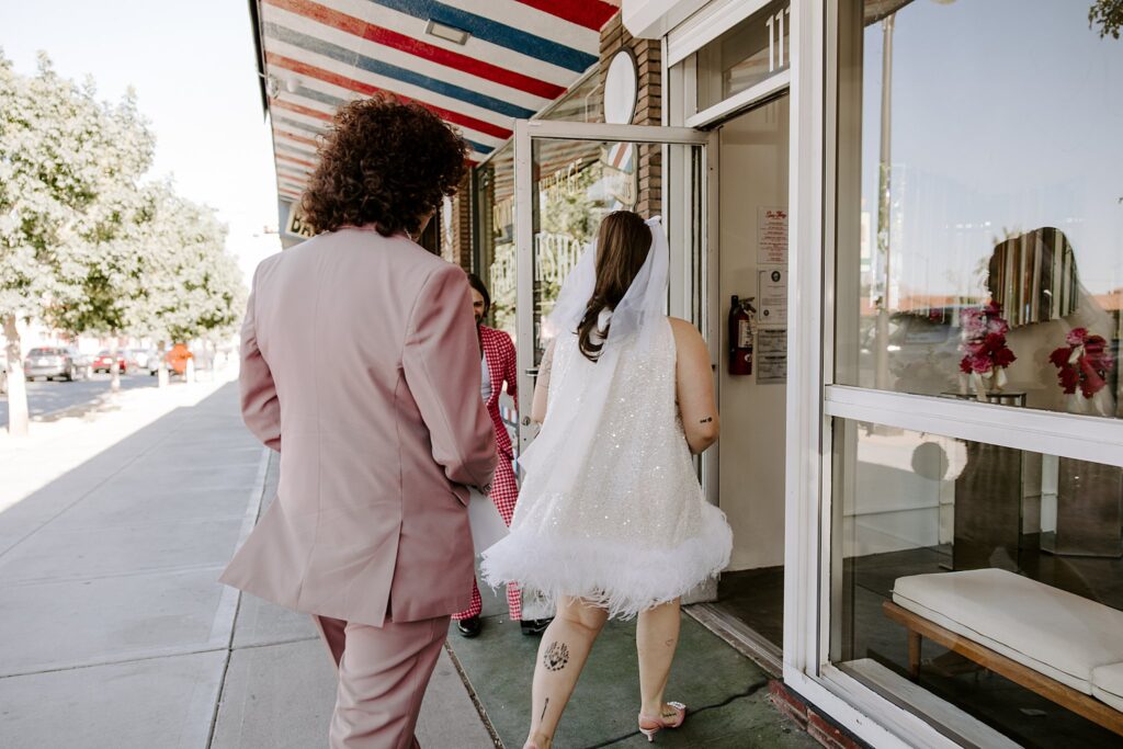 couple walks into wedding chapel by Katelyn Faye Photography