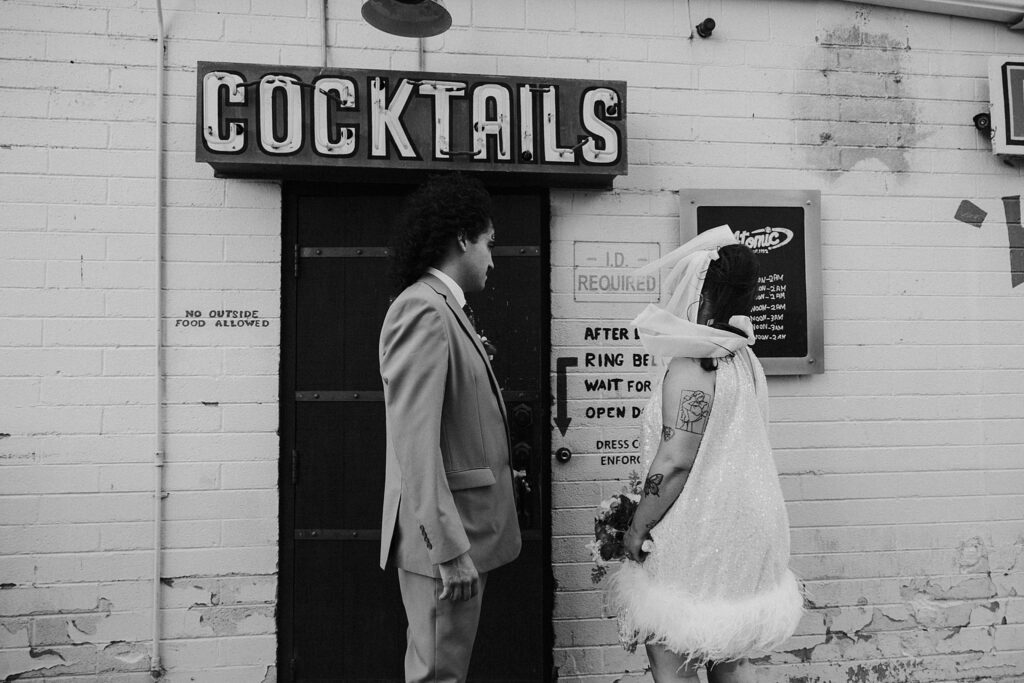 newlyweds walk into restaurant after elopement at Sure Thing Chapel